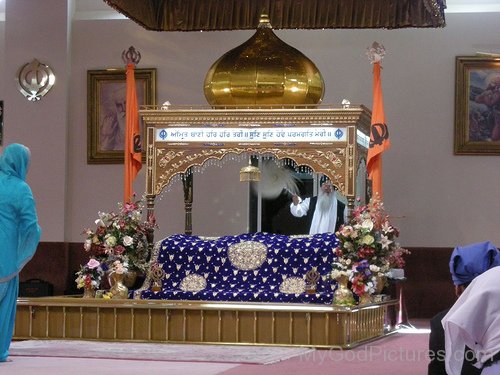 A Lady Paying Obeisance To Guru Granth Sahib Ji