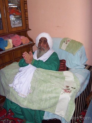 Sitting Image Of Baba Ajit Singh  In Green Dress